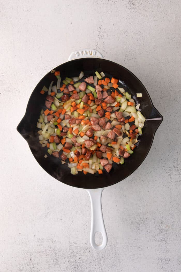 Andouille sausage and vegetables in a cast iron skillet