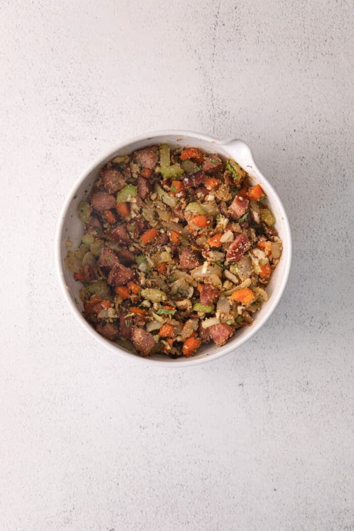 Andouille and pecan stuffing in a white bowl