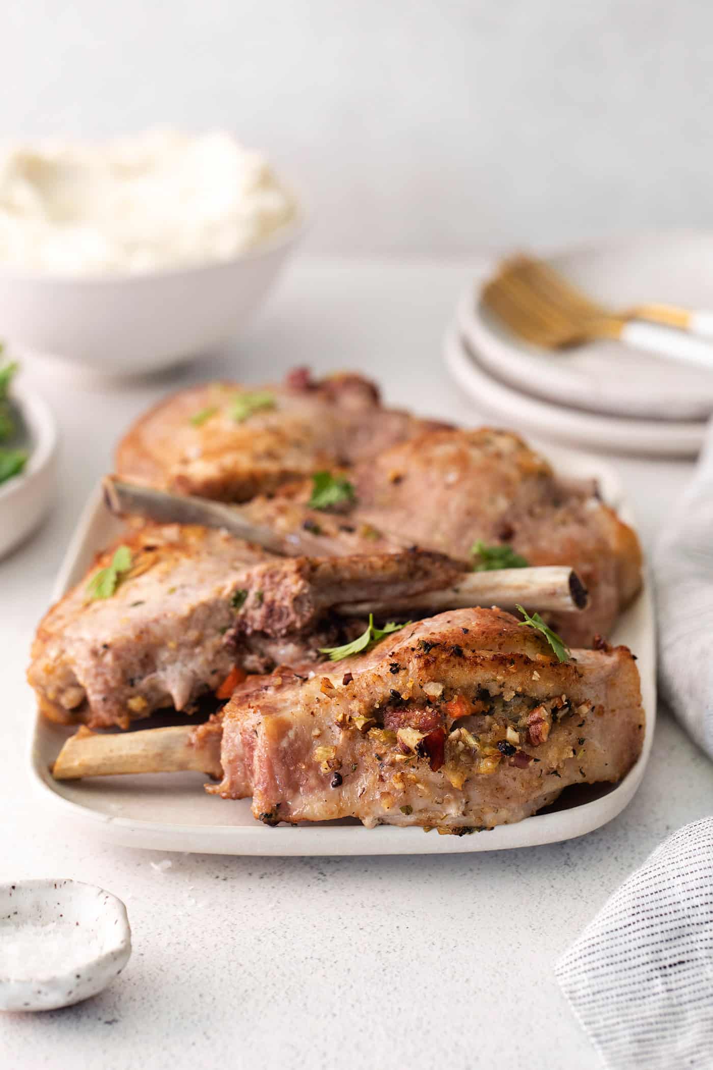 Pork chops with stuffing on a white platter