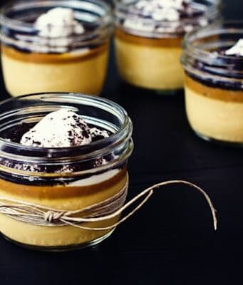Mini jars of caramel custard with salted caramel sauce and whipped cream