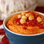 a blue bowl of Roasted Red Pepper Hummus