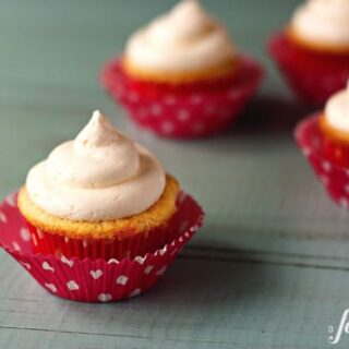 frosted cupcakes with pink wrappers