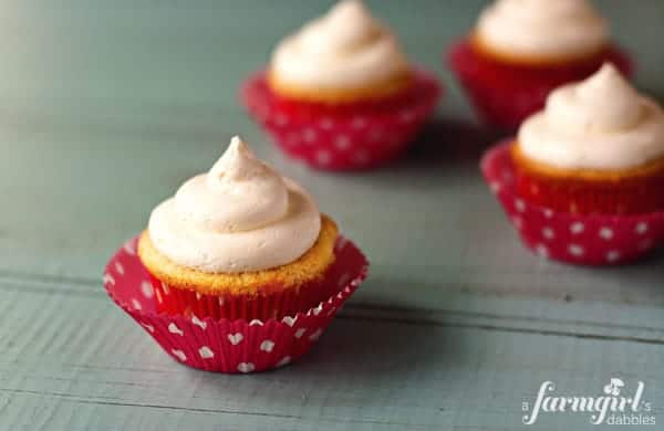 frosted cupcakes with pink wrappers