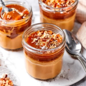 3 caramel pots de creme in glass jars.