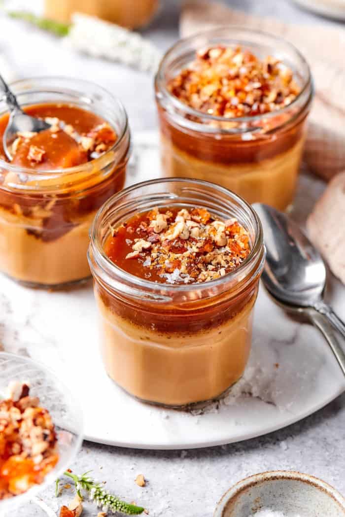 3 caramel pots de creme in glass jars.