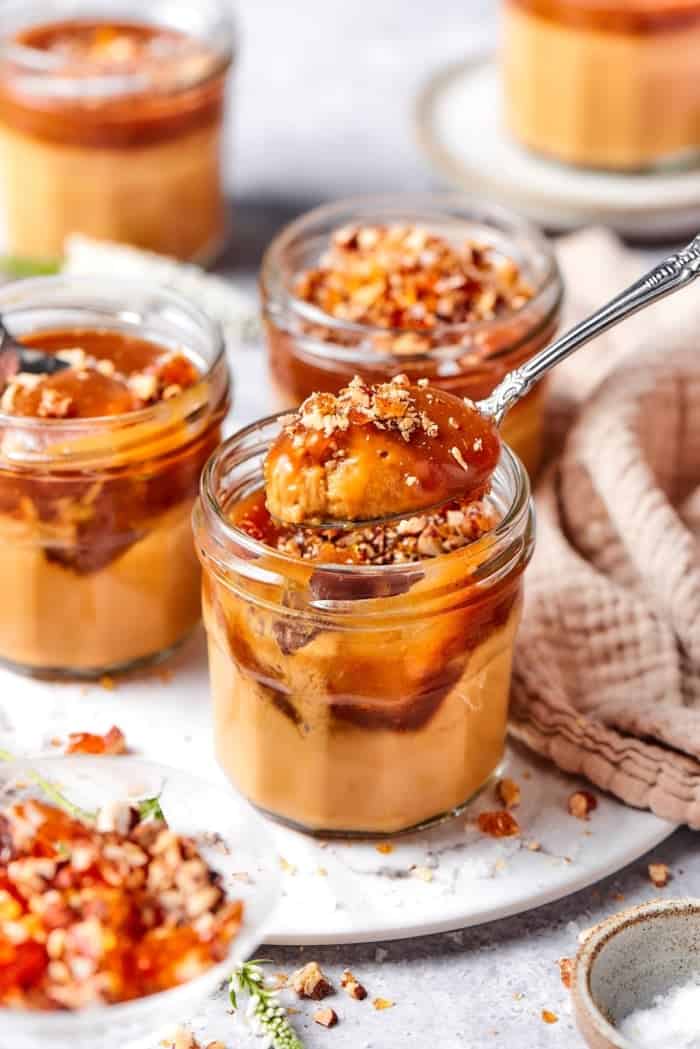 Spoonful of creme and caramel held over custard pot.