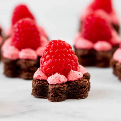 Brownies shaped like flowers, topped with raspberry