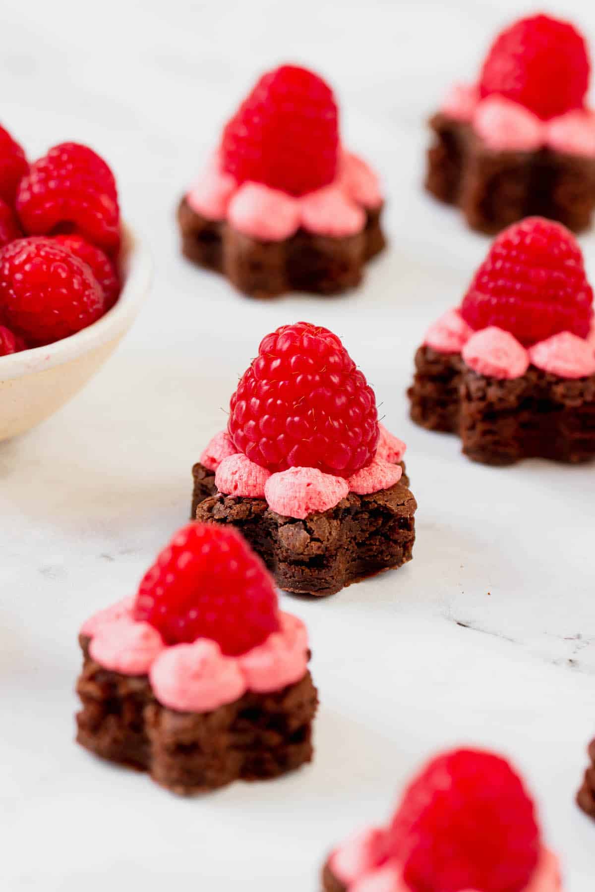 Brownie bites topped with raspberry buttercream frosting