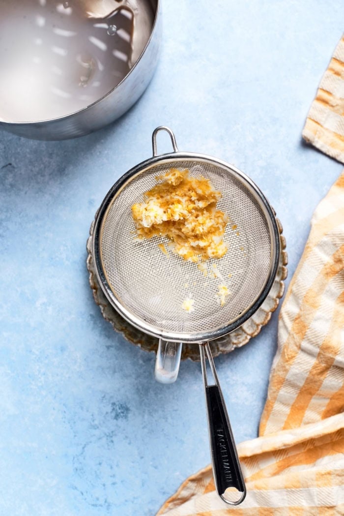 Overhead view of lemon zest in strainer
