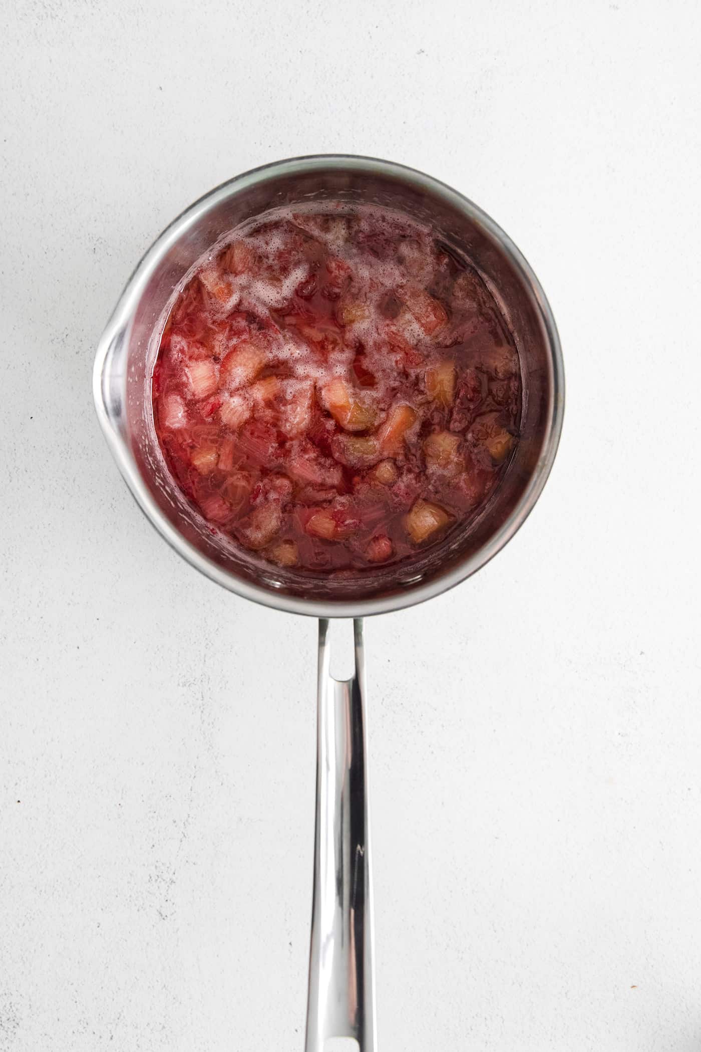 Softened pieces of rhubarb in a sauce pan