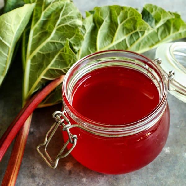 Close up of rhubarb syrup in a glass jar