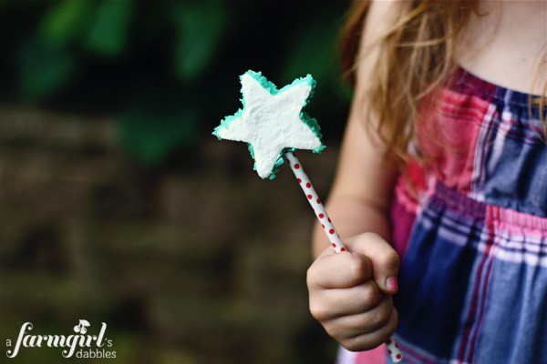 a girl holding a marshmallow pop