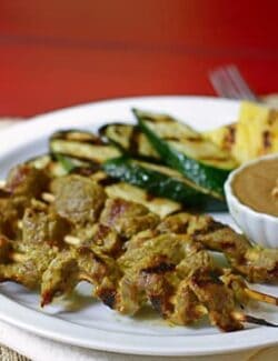 beef skewers and grilled vegetables with peanut dipping sauce