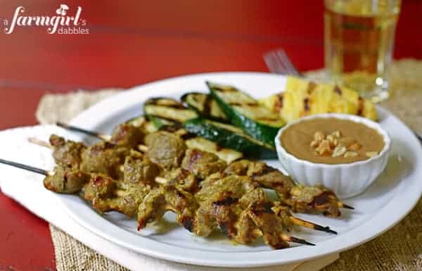 beef skewers and grilled vegetables with peanut dipping sauce