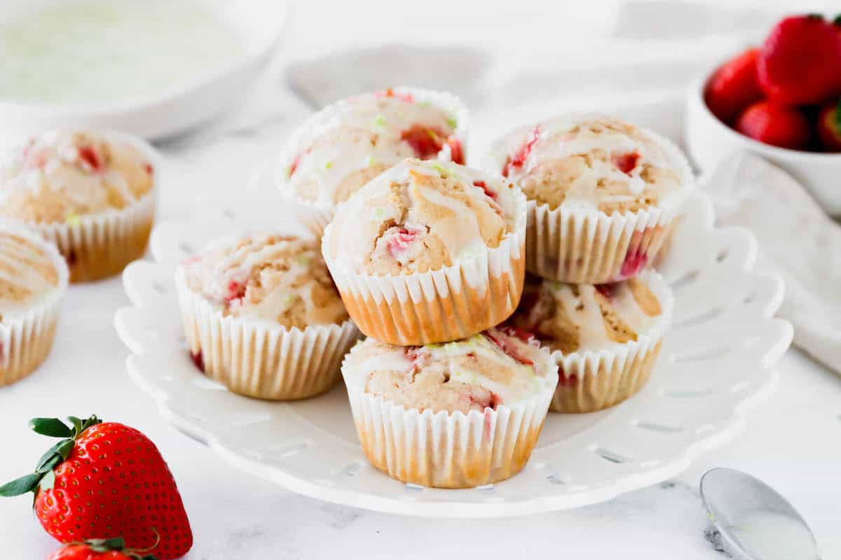 A plate of strawberry muffins with lime glaze