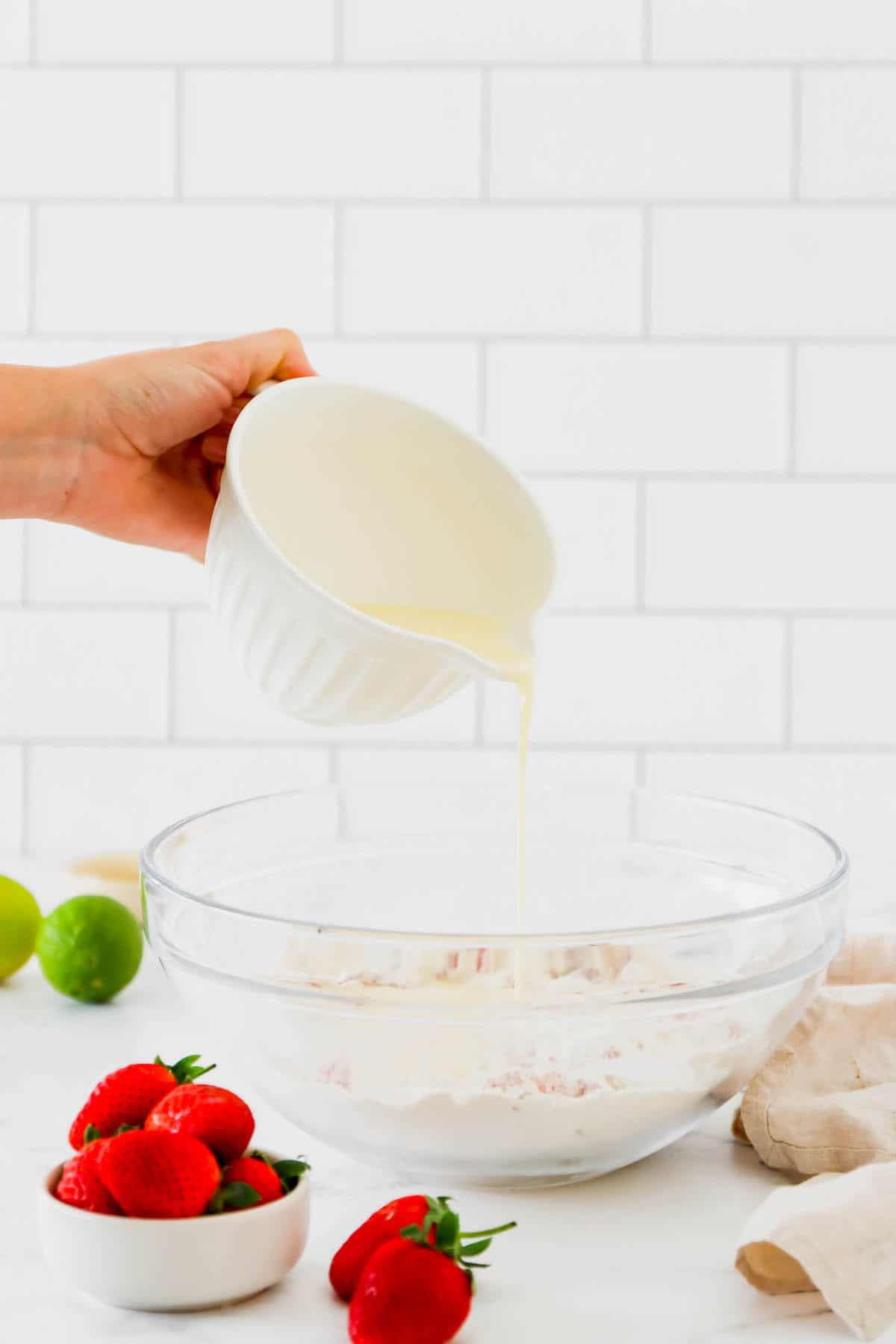 Wet ingredients being poured into dry muffin ingredients