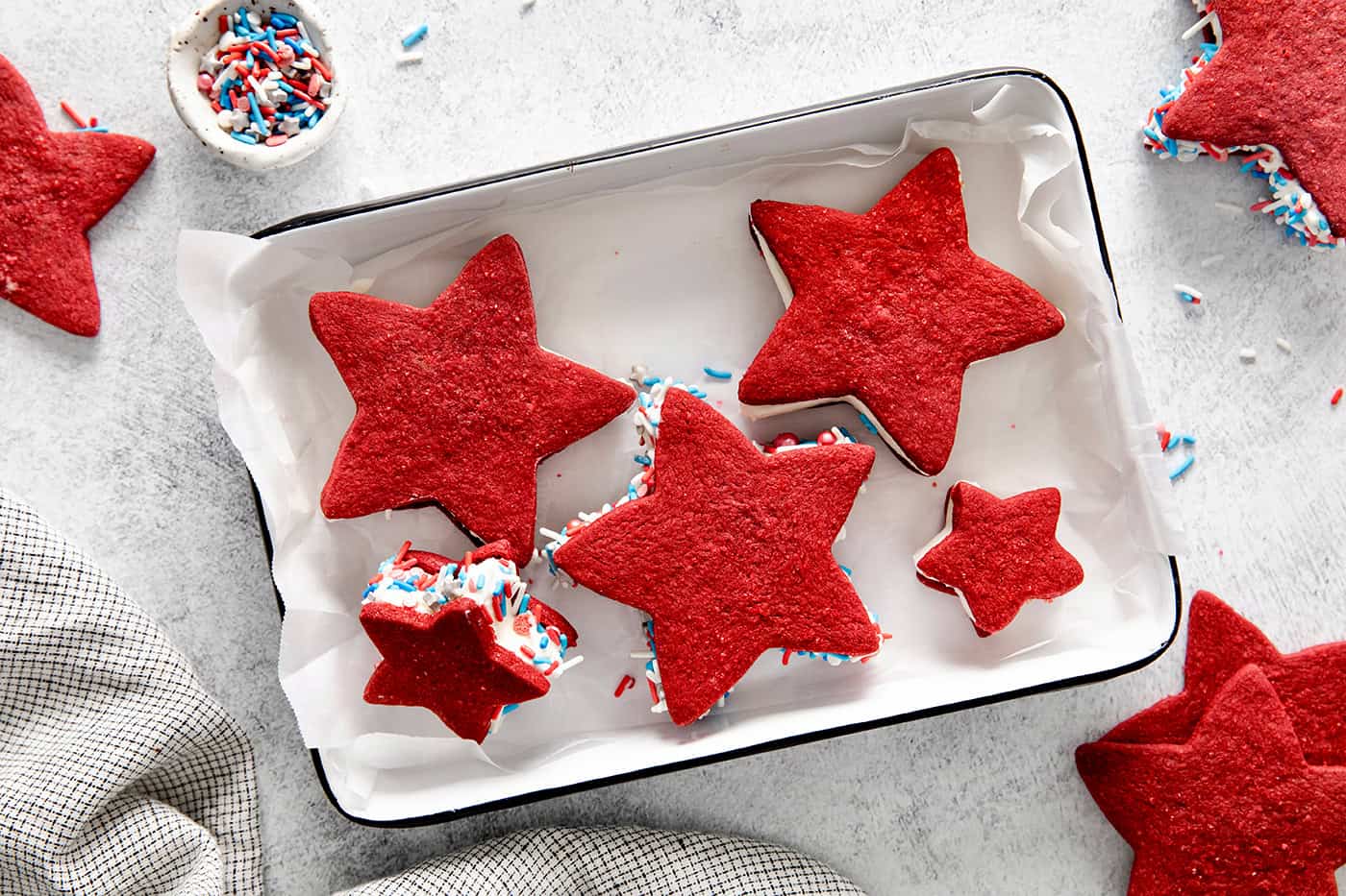 Overhead view of patriotic ice cream sandwiches on a baking sheet