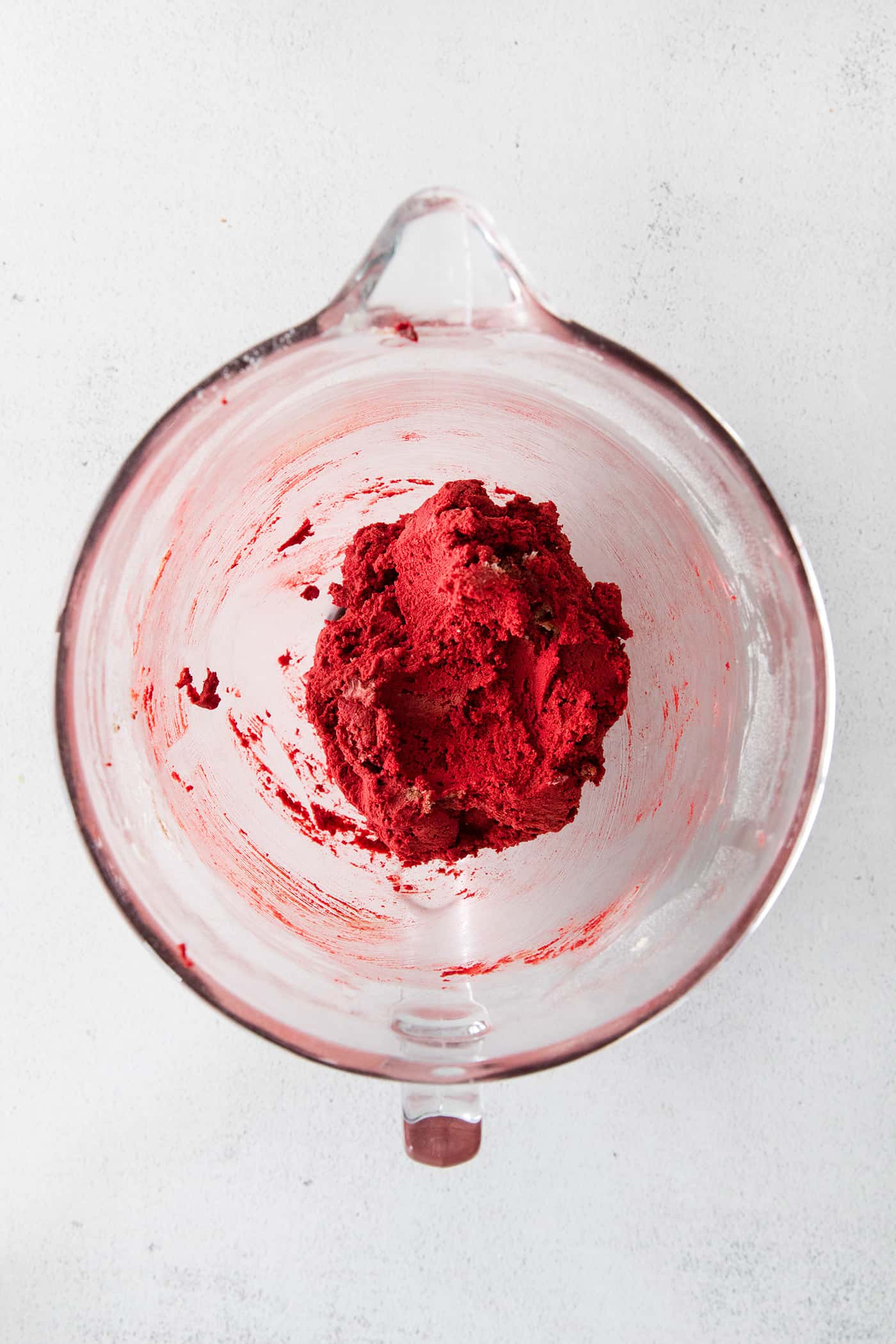 Red velvet shortbread cookie dough in a mixing bowl