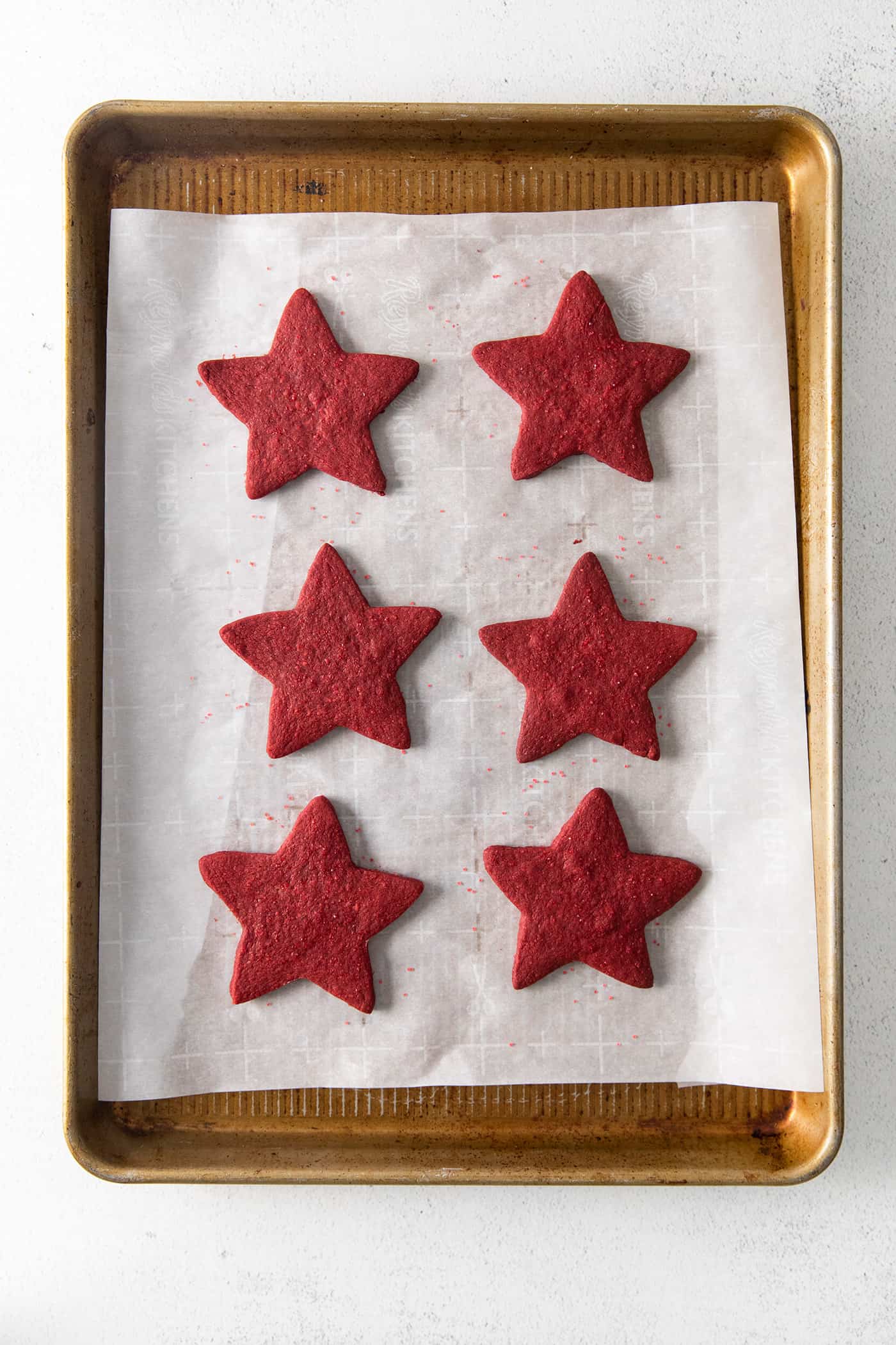 Star shaped red velvet cookies on a baking sheet