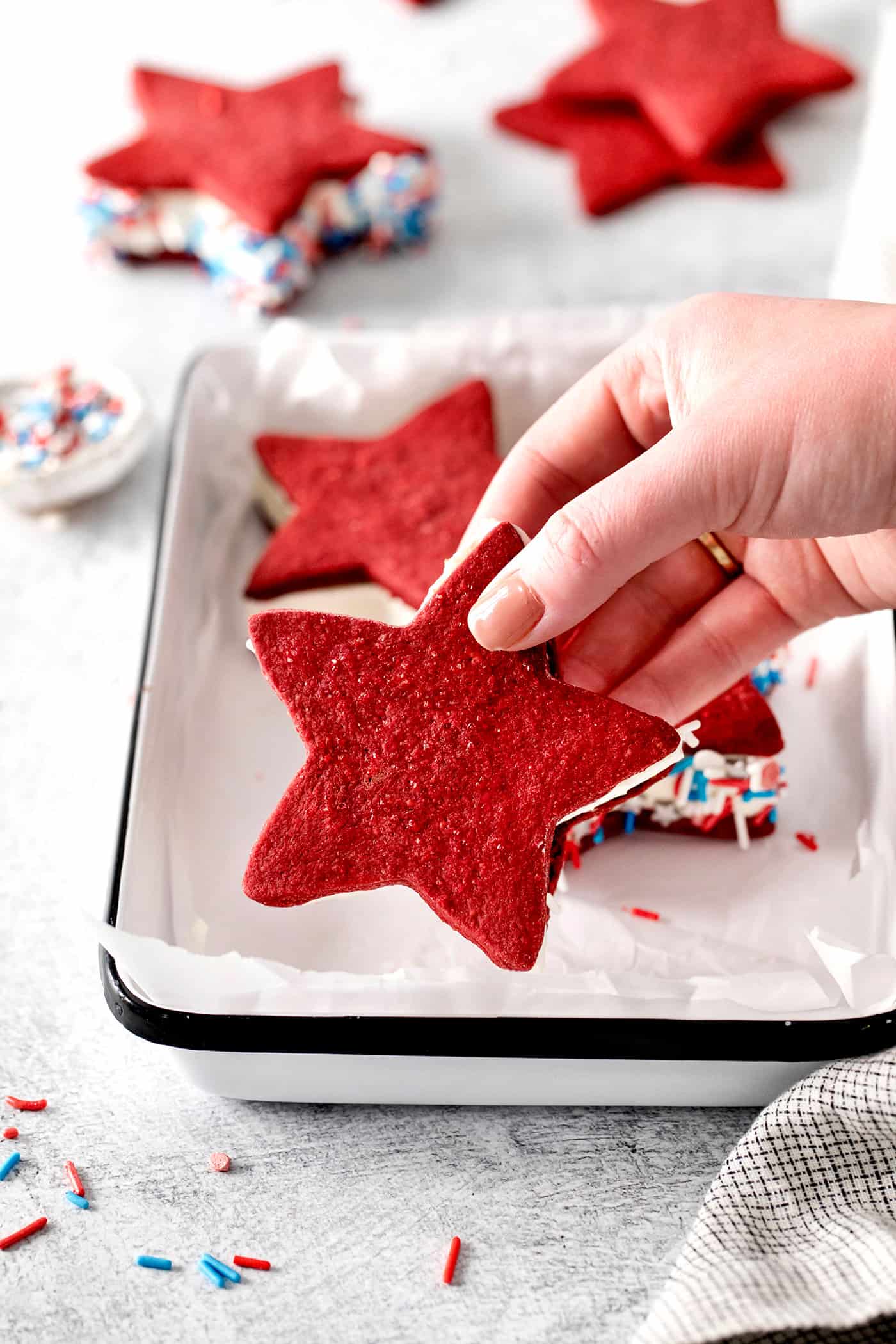 A hand holding a star shaped ice cream sandwich