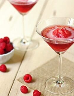 a martini glass with raspberries sorbet