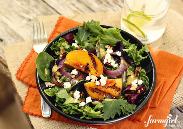 grilled peach slices on a salad