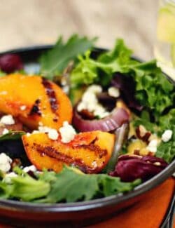 a salad with grilled peaches and onions