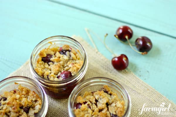 glass jars with cherry crumble