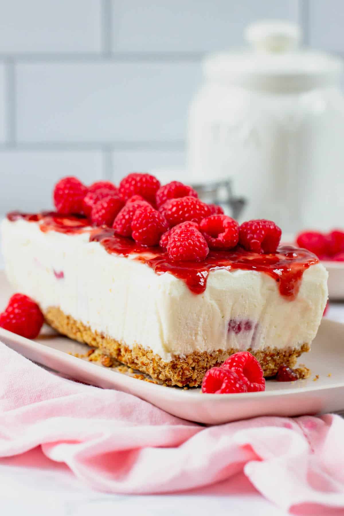 Frozen white chocolate raspberry dessert topped with fresh raspberries