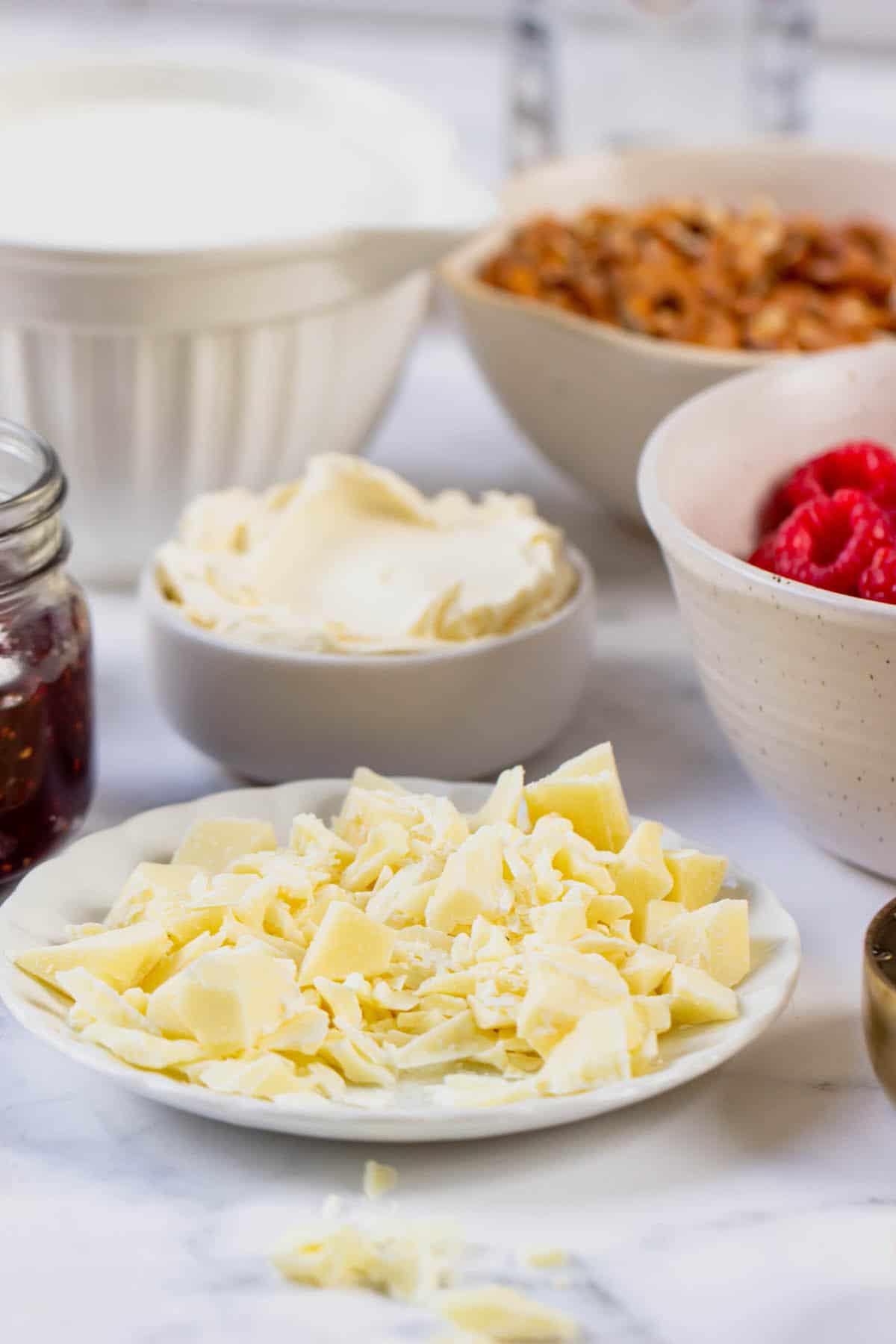 White chocolate on a plate with other ingredients in the background