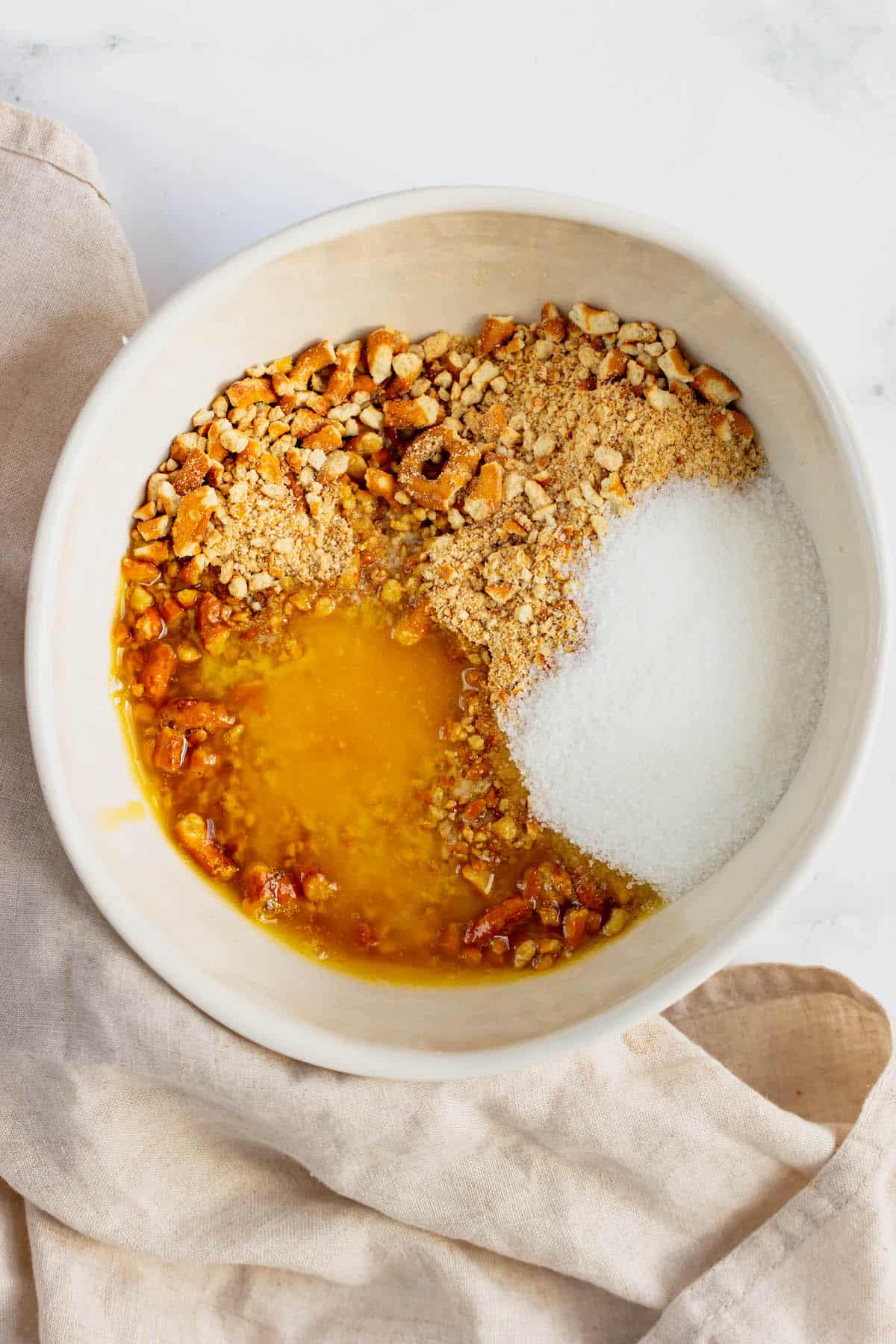 Crushed pretzels, sugar and melted butter in a mixing bowl