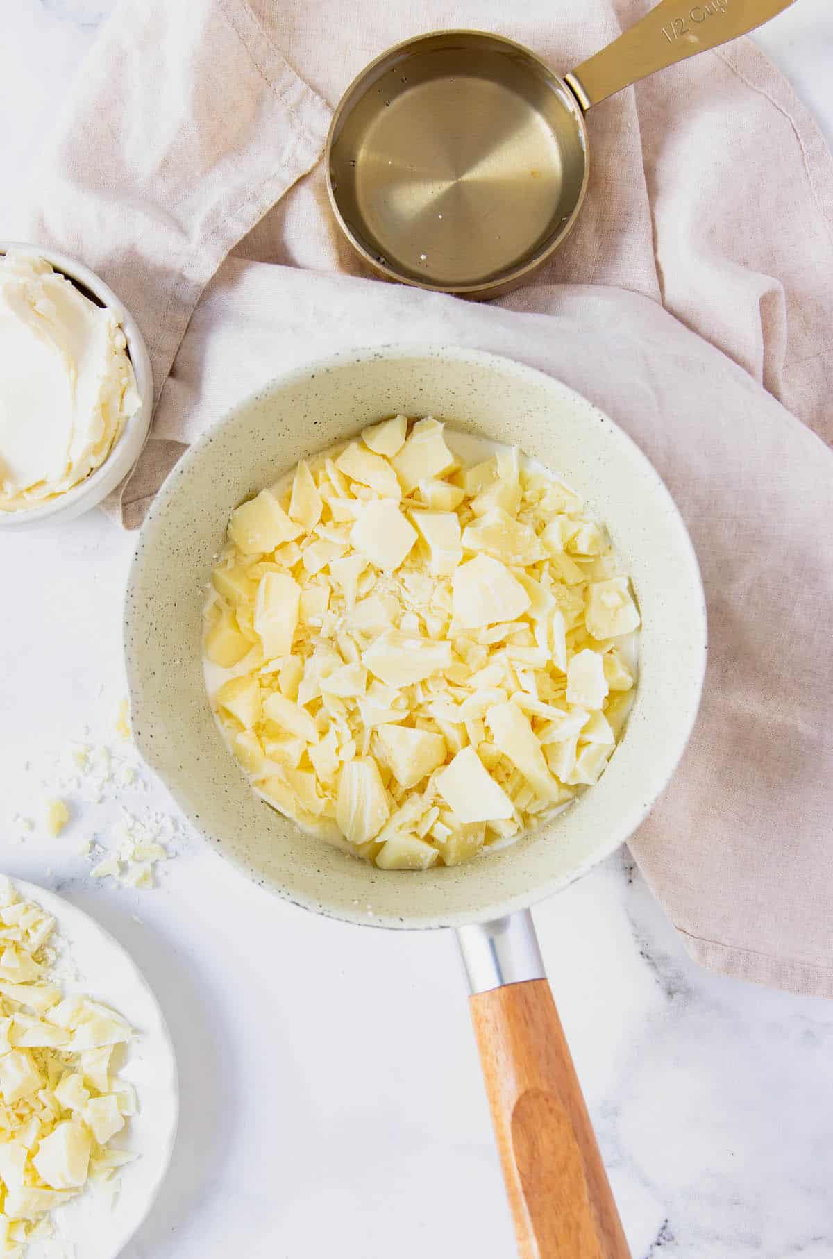 A measuring cup of white chocolate