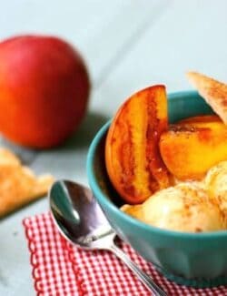 a bowl with grilled peaches, ice cream, and cinnamon pie crust