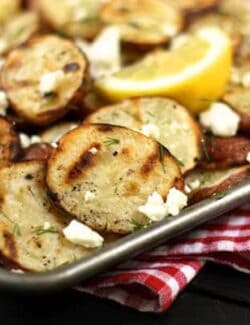 a pan of roasted potatoes with feta and dill