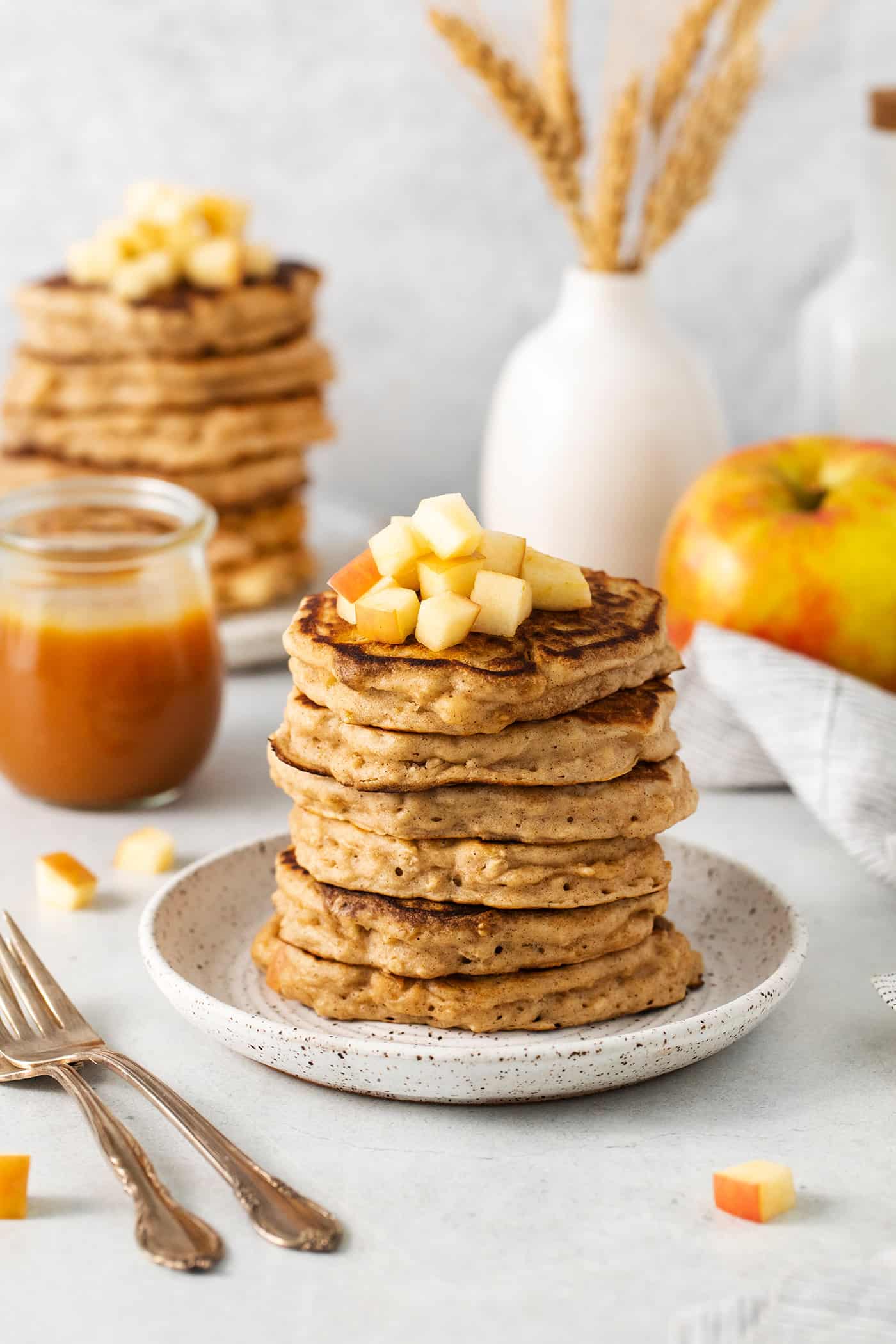 Angled view of a stack of apple oatmeal pancakces