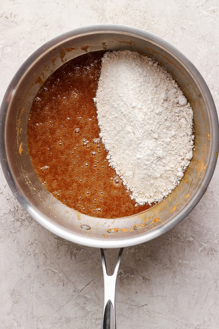 Overhead view of dry ingredients added to pan of liquid ingredients