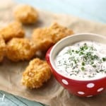 These baked chicken nuggets are crispy and delicious when paired with this dilly ranch dip.