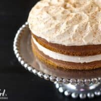 a frosted pumpkin layer cake dusted with cinnamon