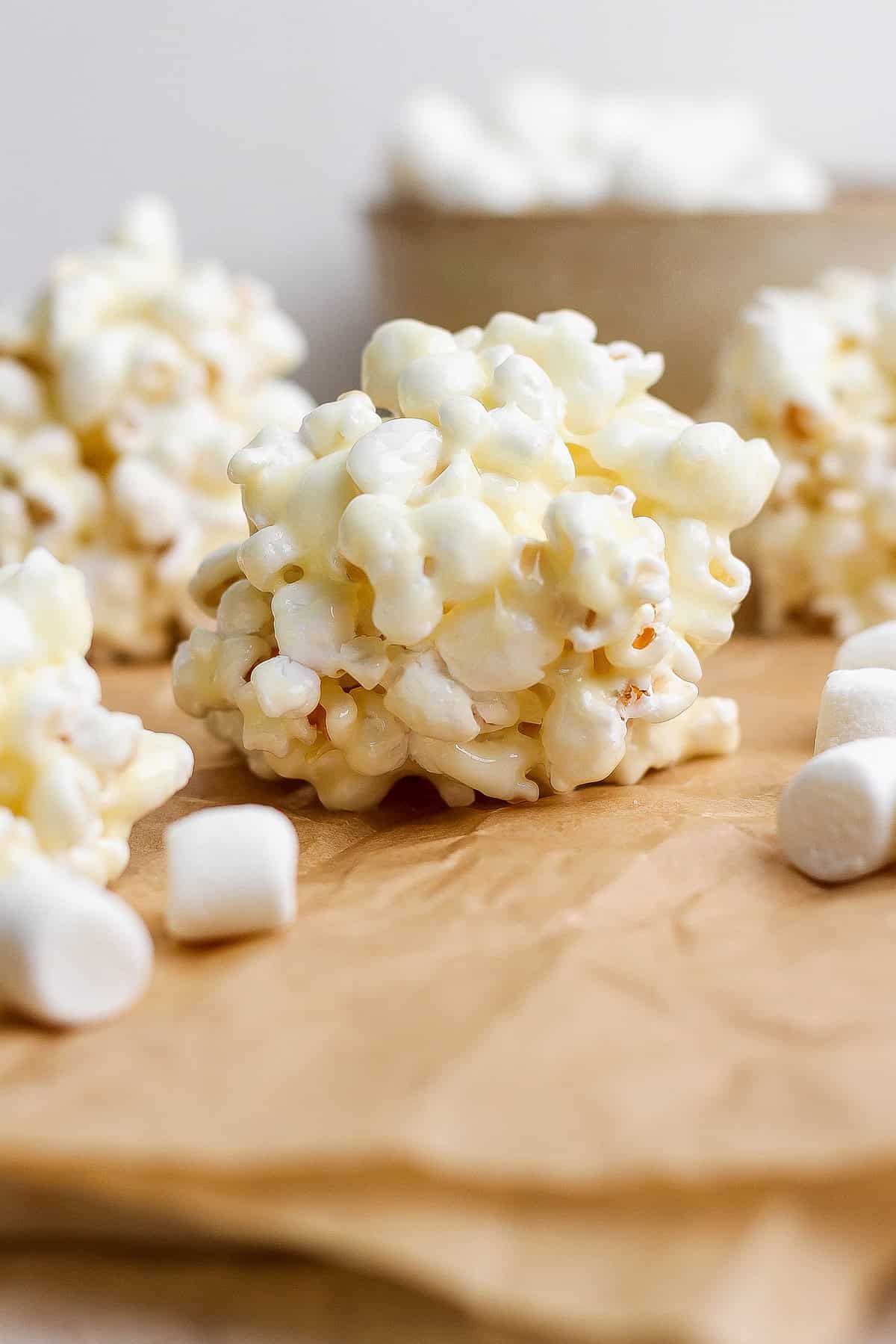 Marshmallow popcorn ball on parchment paper.
