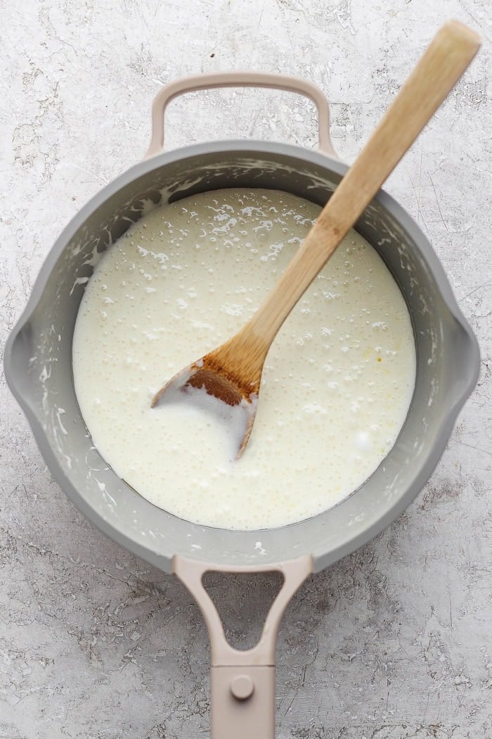 Stirring marshmallow and butter in pan.