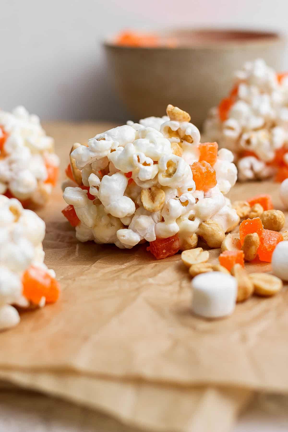Marshmallow popcorn ball made with peanuts and orange gumdrops.