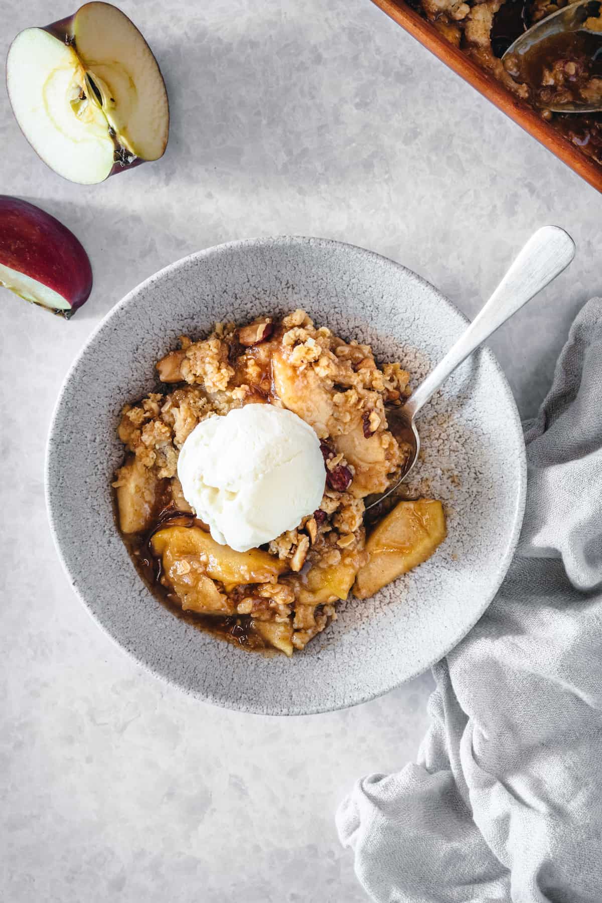 Overhead view of caramel apple almond crisp topped with ice cream