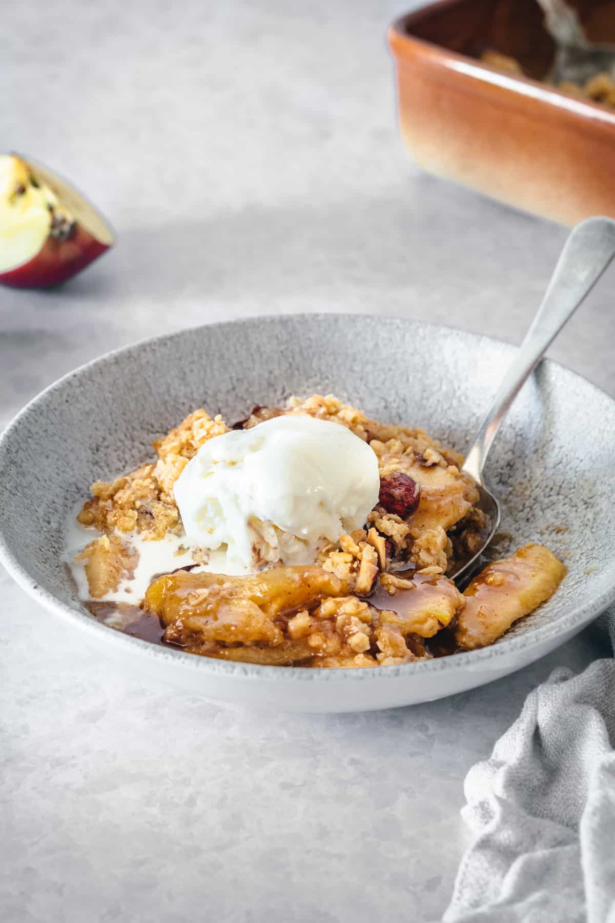 Caramel apple crisp topped with vanilla ice cream