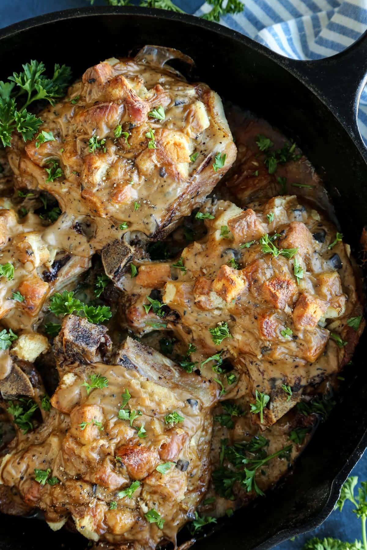 baked pork chops and stuffing in cast iron skillet