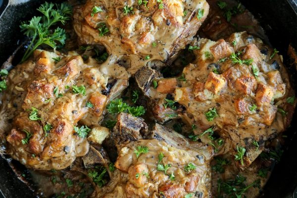 Stuffed pork chops in a skillet.