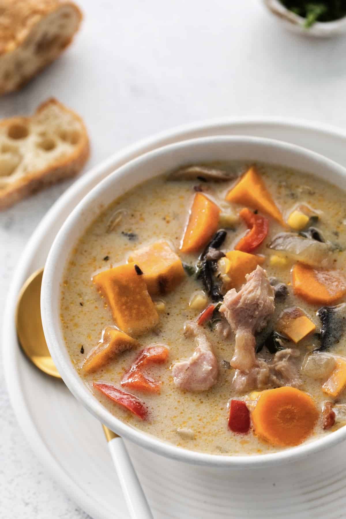 Make this easy Smoked Turkey Chowder recipe in one pot. It's lightly creamy and loaded with flavor, a great way to use up turkey leftovers! Closeup of a bowl of smoked turkey chowder