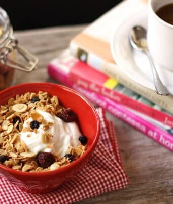 a bowl of yogurt with Granola and a cup of coffee