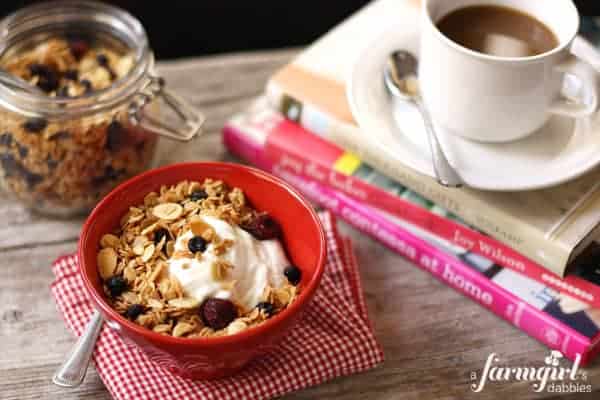a bowl of yogurt with Granola and a cup of coffee