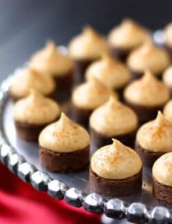 espresso brownie bites topped with kahlua buttercream on a silver cake stand