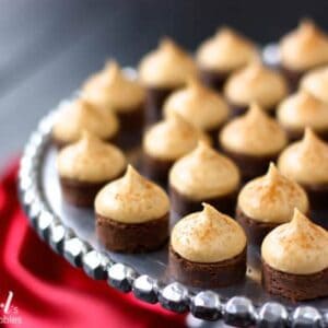 espresso brownie bites topped with kahlua buttercream on a silver cake stand
